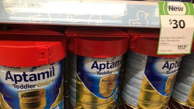 Tins of baby formula with anti-theft devices at a Coles store. Picture: Supplied.