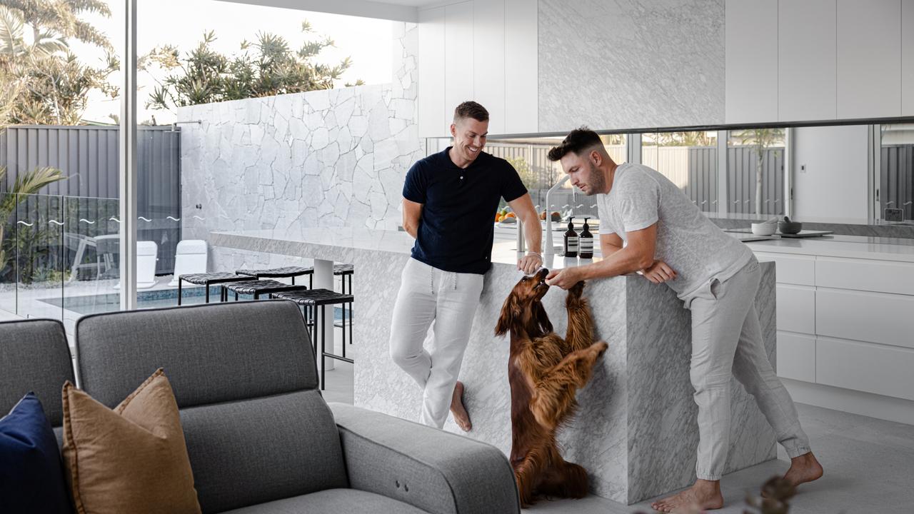 Jarrad Cramp and Josh Dzufer of Nexus Building Group with their dog Saanda after moving in to one of the first high-end duplexes in Buddina, a once sleepy beachside town.