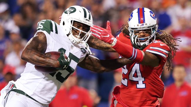 Brandon Marshall #15 of the New York Jets is tackled by Stephon Gilmore #24 of the Buffalo Bills.