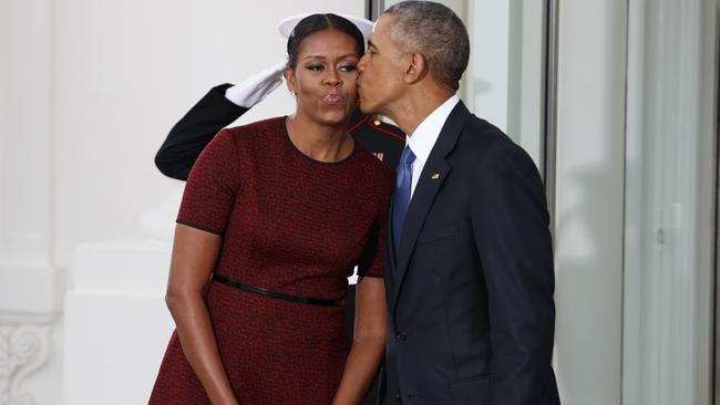 The Obamas shared a peck on the cheek as they waited for the Trumps to arrive. Pic: AFP