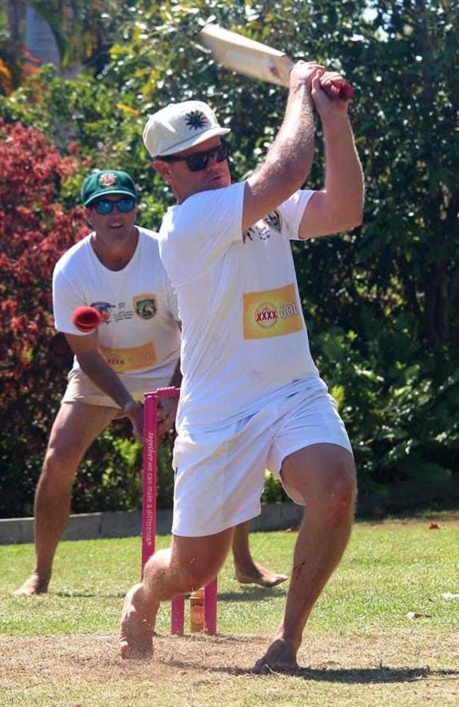 Wicketkeeper Shane Yore watches on as batter Jason Keily hits out during a game in the Yeppoon Backyard Cricket Series.