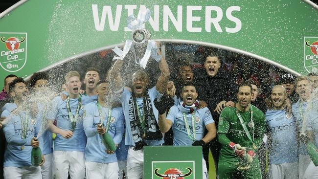 Manchester City's Vincent Kompany, centre lifts the English League Cup