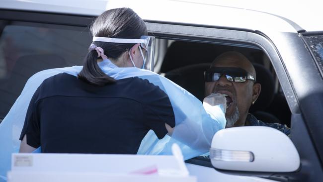 A healthcare worker tests a member of the public at a Covid-19 drive through clinic in Perth. Picture: Getty