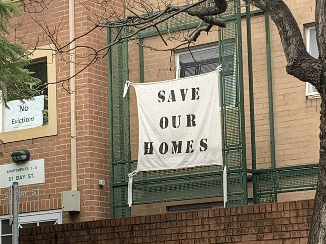 A “Save Our Homes” sign hanging on the social housing block at 45-51 Bay St, Glebe, following a concept development plan by the NSW government late last year to redevelop the site. Picture: Supplied