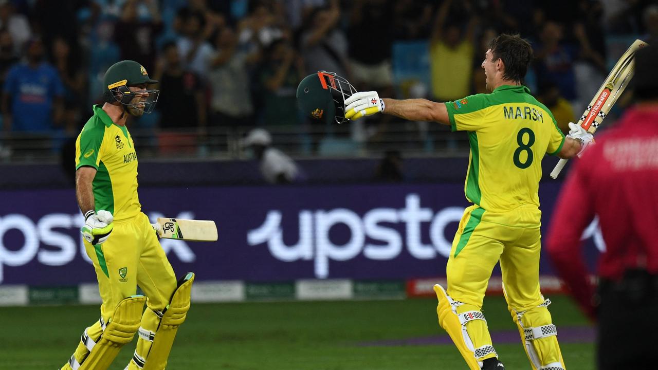 Australia's Mitchell Marsh (R) and Glenn Maxwell celebrate their win in the ICC menâ&#128;&#153;s Twenty20 World Cup final match between Australia and New Zealand at the Dubai International Cricket Stadium in Dubai on November 14, 2021. (Photo by INDRANIL MUKHERJEE / AFP)