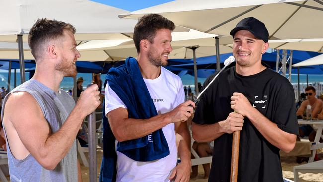 Port captain Travis Boak (centre) with teammates Robbie Gray and Sam Powell-Pepper fixing up the Moseley Beach club after a storm. Picture: Naomi Jellicoe