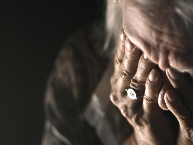 ISTOCK GENERIC -  Desperate senior crying in a dark room. Perfectly usable for a wide range of topics like depression, loneliness or mental health in general.