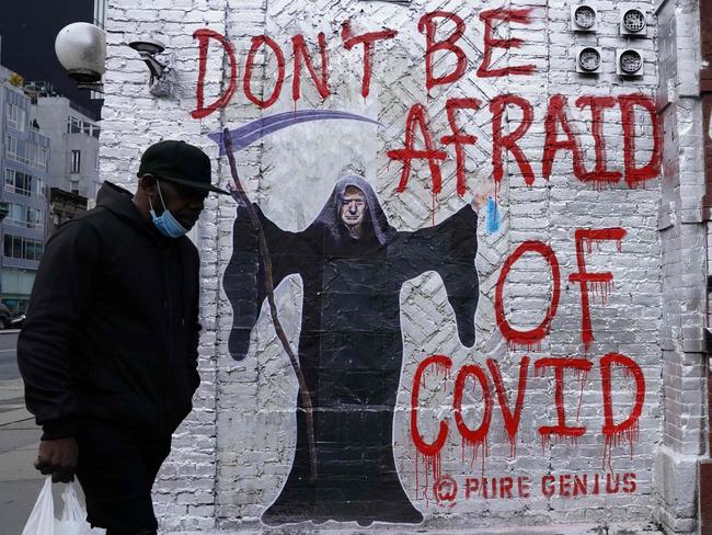 A man walks past a mural depicting US President Donald Trump as the Grim Reaper on a wall on Houston Street in New York City. Picture: AFP