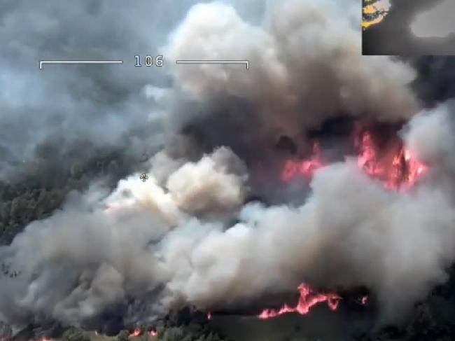 Three mile fire: Fire crews work to save a property at Wiseman's Ferry threatened by the Three mile bushfire.