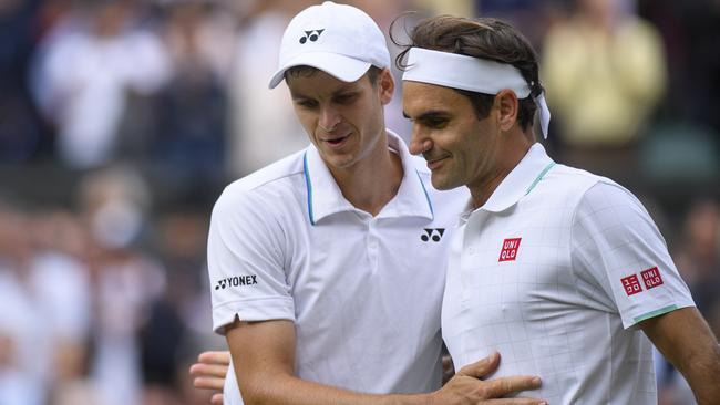 Hubert Hurkacz of Poland with Roger Federer after winning their men's Singles Quarter Final match.