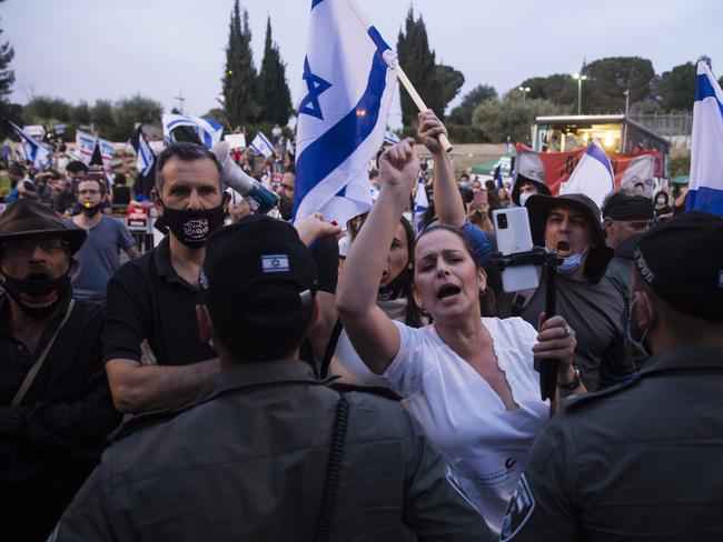 JERUSALEM, ISRAEL - MAY 14:  Israelis confront with Israeli police force as they protest outside the Israeli parliament on May 14, 2020 in Jerusalem, Israel. After three general elections Israeli Prime Minister Benjamin Netanyahu and Blue and White Party leader Benny Gantz will form biggest government in Israel's history, to be sworn in this Sunday.  (Photo by Amir Levy/Getty Images)