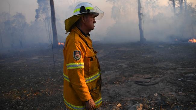 NSW Rural Fire Service volunteer Bob Kneipp, is seen after successfully defending a property in Torrington, near Glen Innes, Sunday. Picture: AAP