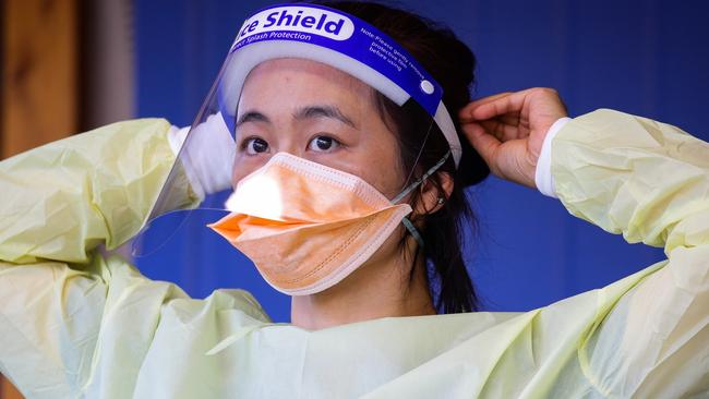 SYDNEY, AUSTRALIA - NewsWire Photos APRIL 05, 2021:  A nurse is seen adjusting her protective face mask while working at the Covid Testing Clinic at the Royal North Shore Hospital on Easter Monday afternoon in Sydney, Australia. Picture: NCA NewsWire / Gaye Gerard