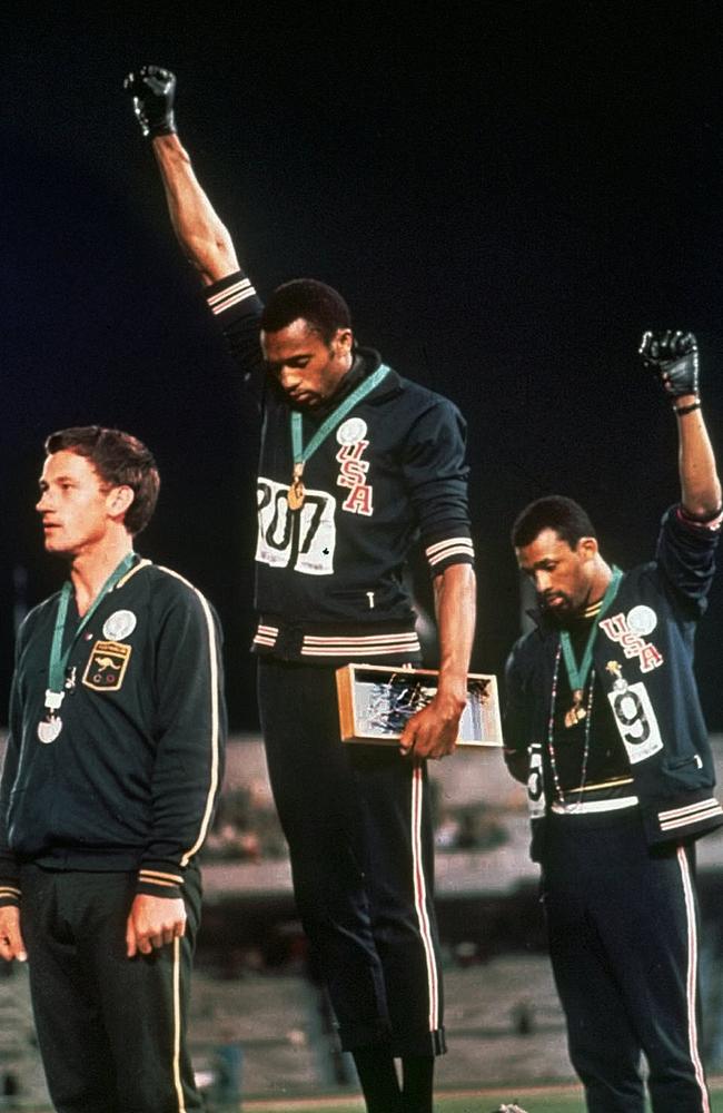 The iconic image of US athletes Tommie Smith, centre, and John Carlos staring downward during the Star-Spangled Banner at the 1968 Olympics in Mexico. Australian silver medallist Peter Norman is at left.