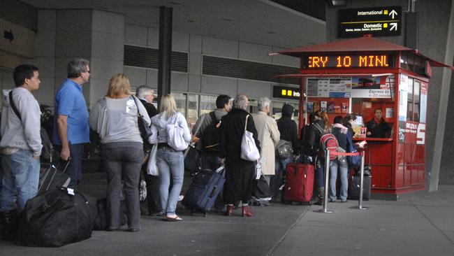 Commuters queue for a SkyBus ticket at Melbourne Airport.