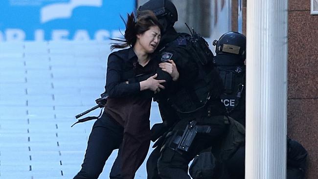 One of the Lindt Cafe staff escapes from the siege. Picture: Adam Taylor