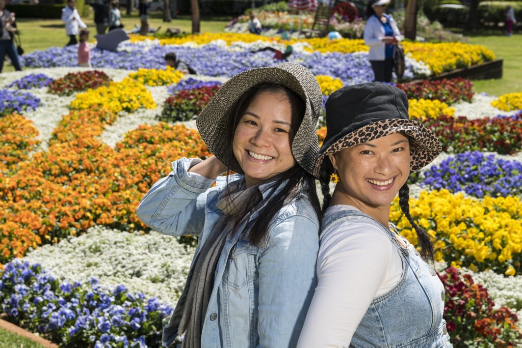 Sisters Kim Huynh (left) and Lyn Ha in Laurel Bank Park during Carnival of Flowers 2020, Saturday, September 26, 2020. Picture: Kevin Farmer