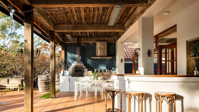 The open plan living/dining area at 38 Portside Place, Bulimba seamlessly flows out onto the Entertaining Alfresco with a barbecue and pizza oven.