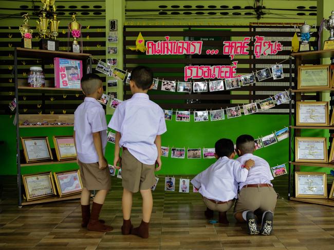 Classmates of Adul, one of the boys trapped in Tham Luang Nang Non cave, visit a tribute for the Wild Boars soccer team at the entrance of Ban Waingphan school. Picture: Getty