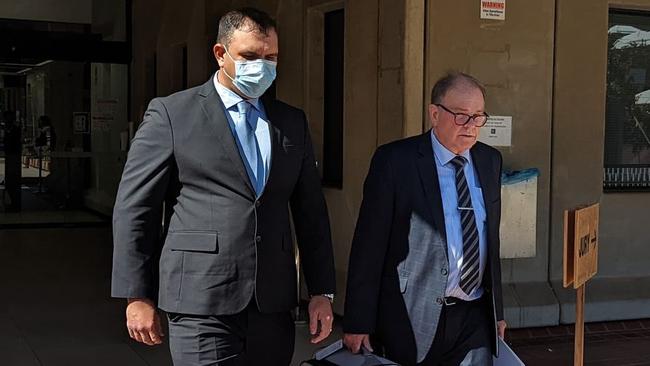 Plainclothes Senior Constable Anthony Ross Patrick Stout (left) leaving Townsville Magistrates Court.