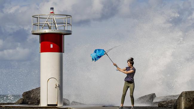 Tarsha Talebi struggling with her umbrella in the strong winds at the Spit. Photo: Jerad Williams