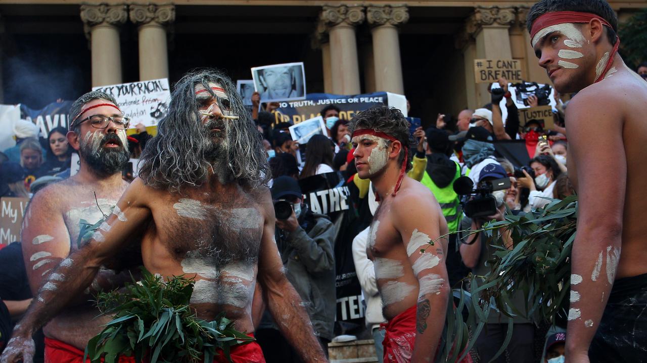 Aboriginal protesters conduct a traditional smoking ceremony at the protest in Sydney. Picture: Lisa Maree Williams/Getty Images