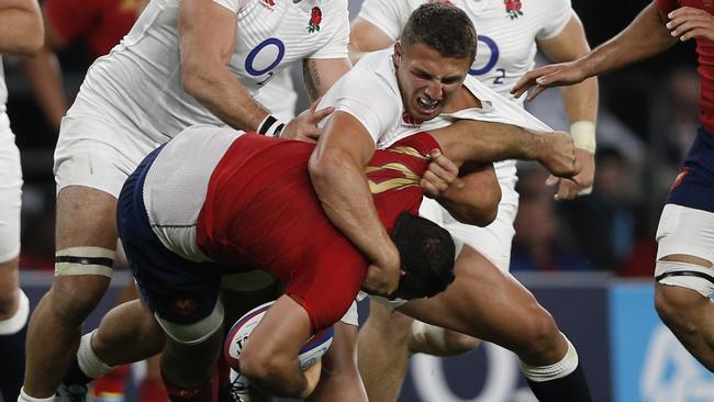 England centre Sam Burgess tackles France prop Nicolas Mas.