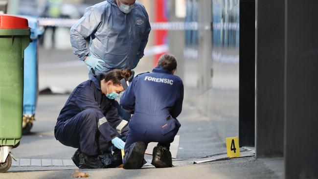 Forensic crews gather evidence. Picture: David Crosling