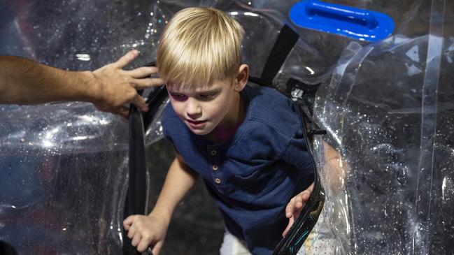 Lawson Bill emerges from the water walking balls in sideshow alley at the Toowoomba Royal Show, Thursday, March 30, 2023. Picture: Kevin Farmer