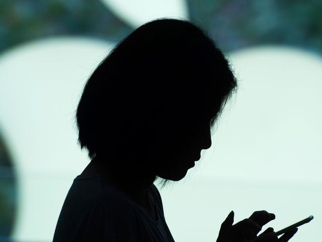 (FILES) This file photo taken on September 25, 2015 shows a customer using her new smartphone during the release of the iPhone 6s at an Apple store in Shanghai.  Several Chinese iPhone users have claimed that their handsets caught fire or exploded, according to a Shanghai consumer watchdog which called on tech giant Apple to address the complaints.  / AFP PHOTO / Johannes EISELE