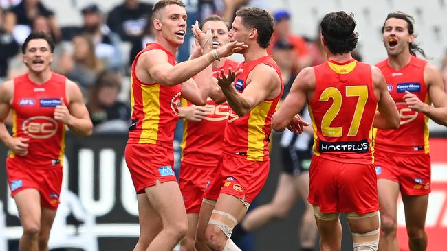 Josh Corbett enjoys a goal during Gold Coast’s comprehensive win.