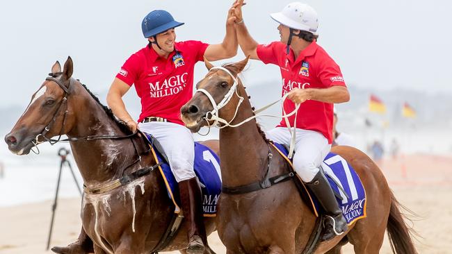 Billy Slater and Nacho Figueras high five at the Magic Millions Barrier Draw. Picture: Luke Marsden.