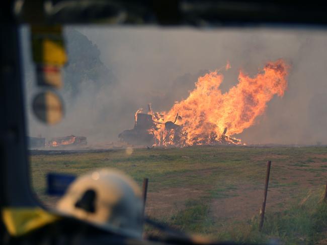 Locals and RFS volunteers battle to save homes in and around the village of Killabakh. Picture: Gary Ramage