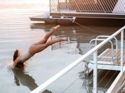 A screenshot from the South Australia Facebook page showing a woman diving headfirst into the Murray