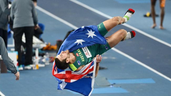 Liam Adcock celebrates with a flip after winning bronze in the long jump. Picture: Hannah Peters/Getty Images