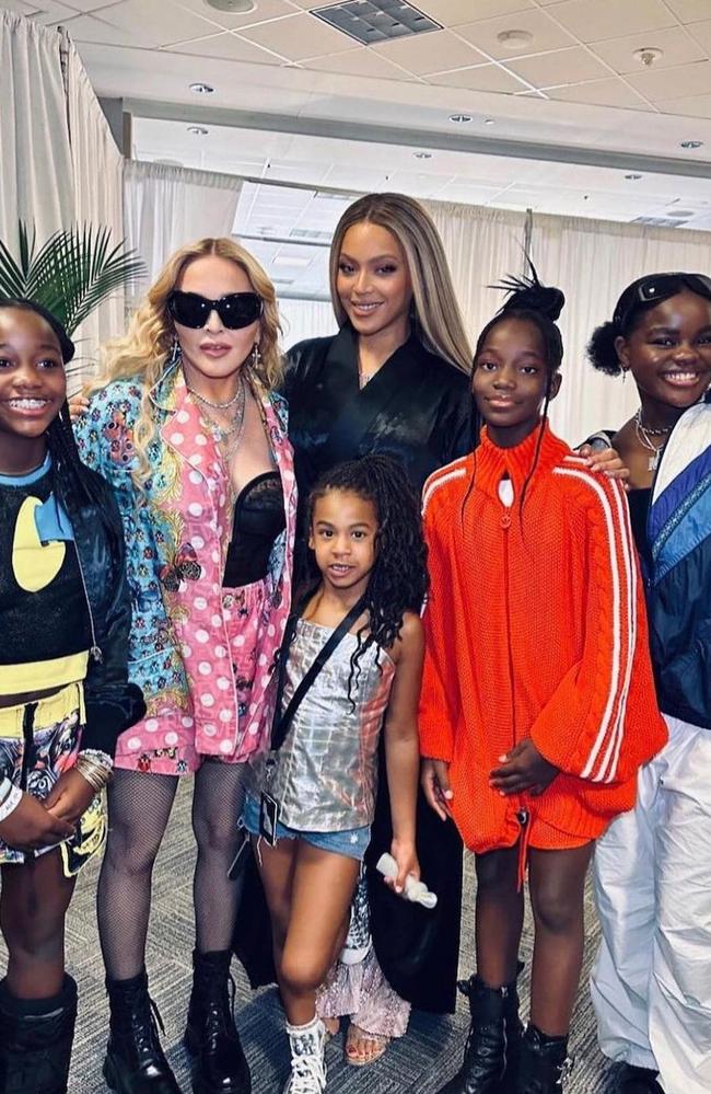 Beyonce and her daughter Rumi pictured backstage with Madonna and her three daughters.