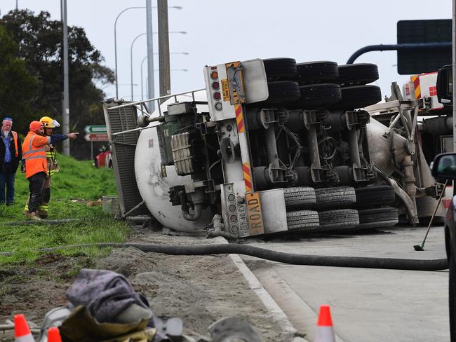 Cement truck roll over on the South road and Southern Expressway connection Hackham being emptied before it can be removed .Thursday July 11,2019.(Image AAP/Mark Brake)