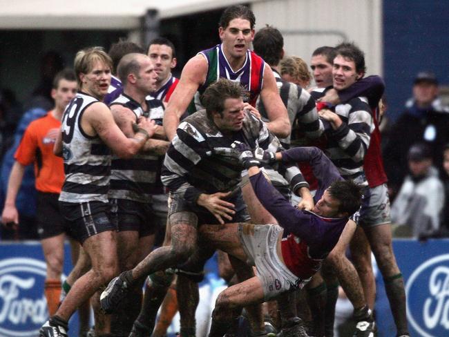 MELBOURNE, AUSTRALIA - AUGUST 14: Joel Corey #11 for Geelong wrestles with Byron Schammer #3 for Fremantle during the round twenty AFL match between the Geelong Cats and the Fremantle Dockers played at Skilled Stadium on August 14, 2004 in Geelong, Australia. (Photo by Hamish Blair/Getty Images)