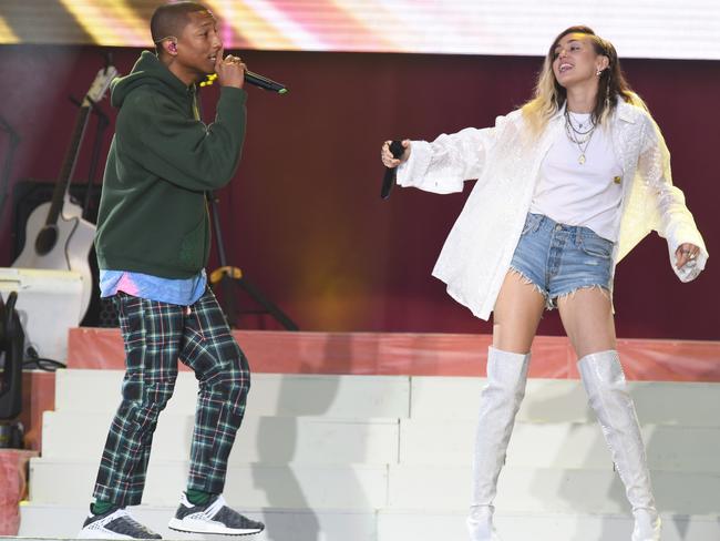 Pharrell Williams and Miley Cyrus perform on stage. Picture: Getty Images/Dave Hogan for One Love Manchester