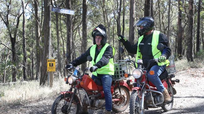 Volunteers on motorbikes search bushland. Picture: NCA NewsWire / David Crosling