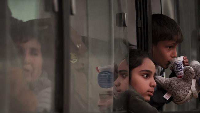 Young refugees sit in a bus near a Red Cross registration centre in Goris. Picture: AFP