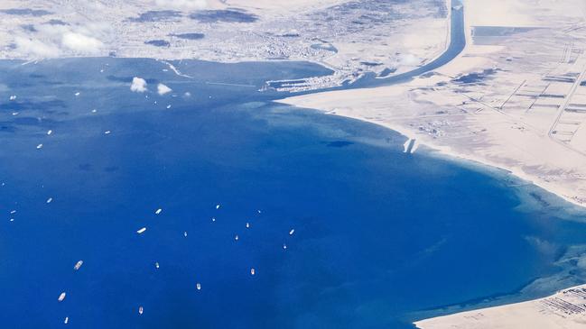 A photo taken from the porthole of a commercial plane shows stranded ships waiting in queue in the Gulf of Suez to cross the Suez Canal. Picture: AFP