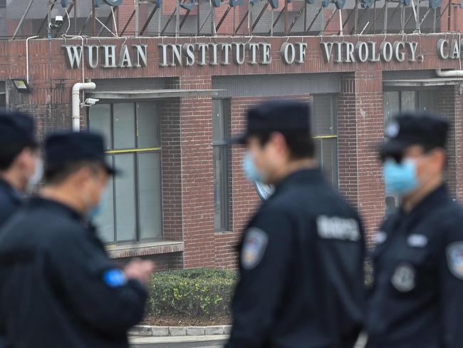 Security personnel stand guard outside the Wuhan Institute of Virology in Wuhan as members of the World Health Organization (WHO) team investigating the origins of the COVID-19 coronavirus make a visit to the institute in Wuhan in China's central Hubei province on February 3, 2021. (Photo by Hector RETAMAL / AFP)