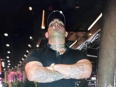 Slain gangster Mahmoud “Brownie” Ahmad poses with arms crossed.