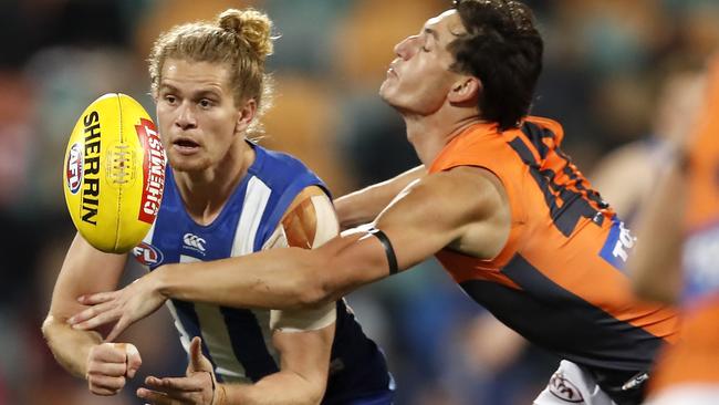 HOBART, AUSTRALIA - JUNE 16: Jed Anderson of the Kangaroos handpasses the ball during the 2019 AFL round 13 match between the North Melbourne Kangaroos and the GWS Giants at Blundstone Arena on June 16, 2019 in Hobart, Australia. (Photo by Dylan Burns/AFL Photos via Getty Images)