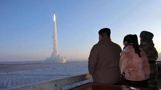 Kim Jong-un (L) and his daughter watching the test launch of a Hwasongpho-18 intercontinental ballistic missile (ICBM) at an undisclosed location in North Korea. KCNA/AFP.