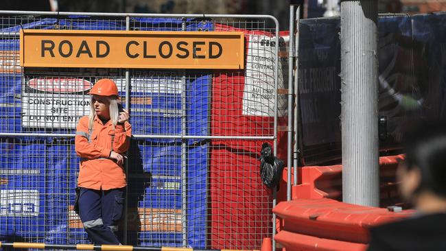 A traffic control worker on the corner of George St and Druitt St, Sydney. Picture: Dylan Robinson