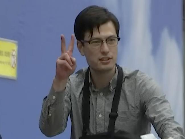 Australian student Alex Sigley gestures as he arrives at the airport in Beijing. Picture: AP Photo/Emily Wang