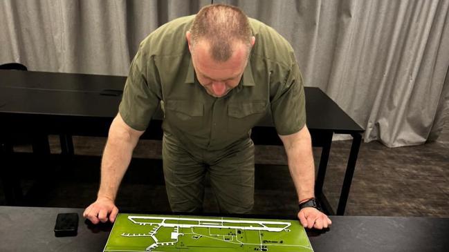 Head of Ukraine’s Security Service Vasyl Malyuk looking at a map showing a Russian military aircraft base, amid the Russian invasion of Ukraine. Picture: AFP