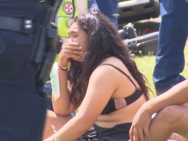 A girl waits for treatment at the scene. Picture: John Tesoriero